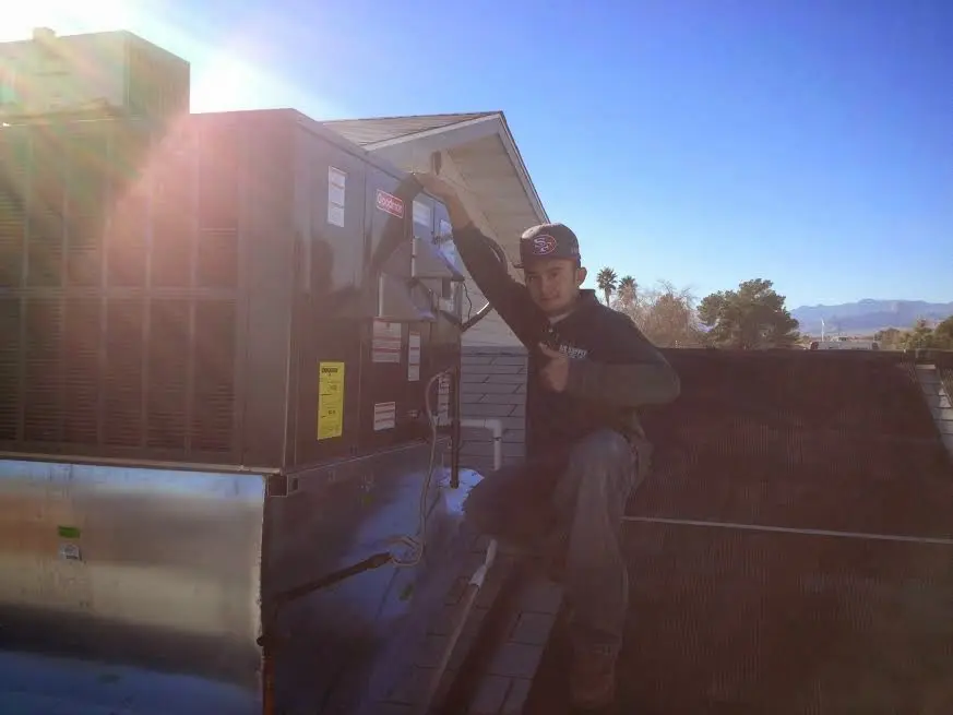HVAC technician performing HVAC Inspection on a rooftop unit in Potomac Park